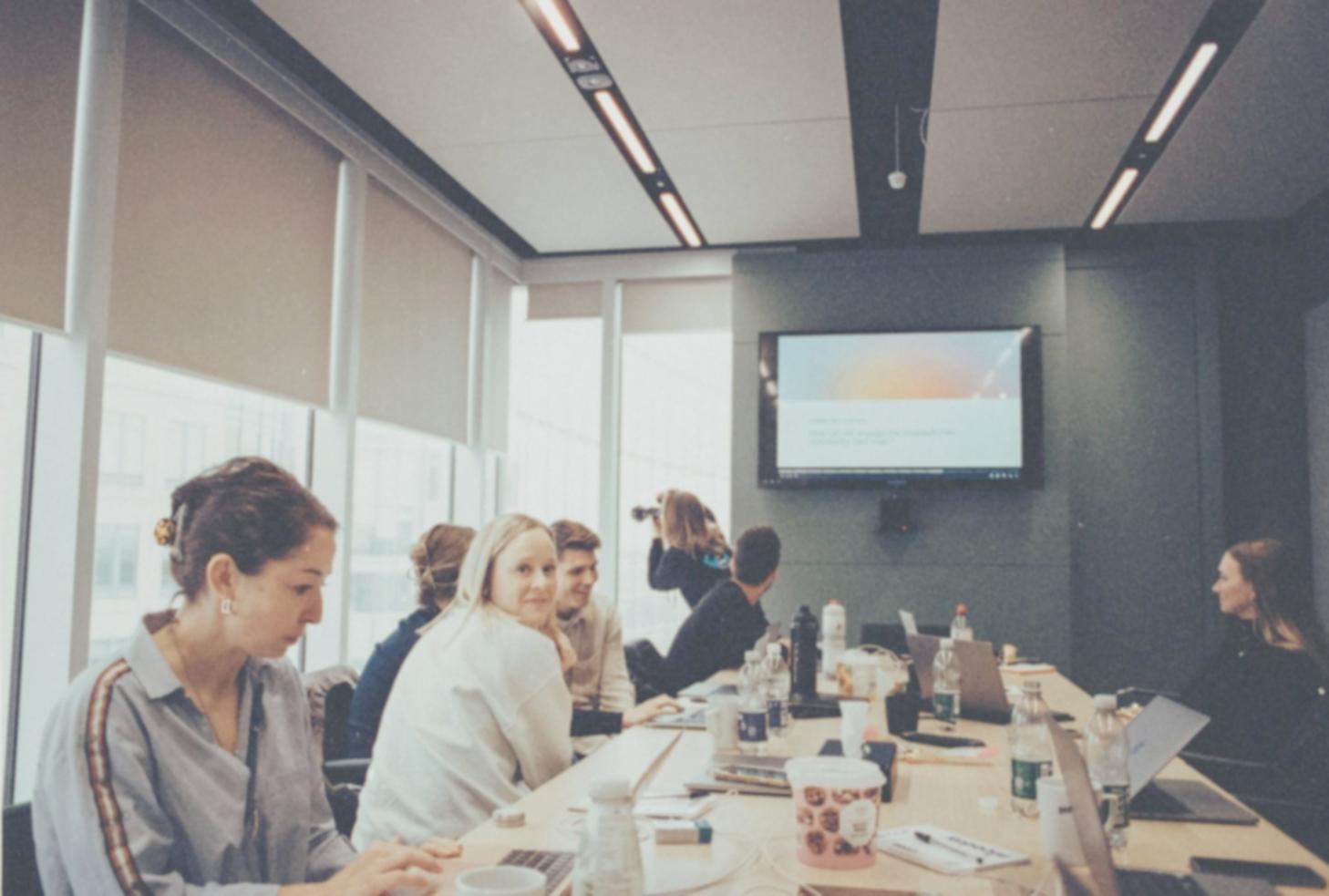 Modern classroom setup with financial data displays and collaborative learning environment